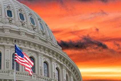 US Capitol on dramatic sunset gold background