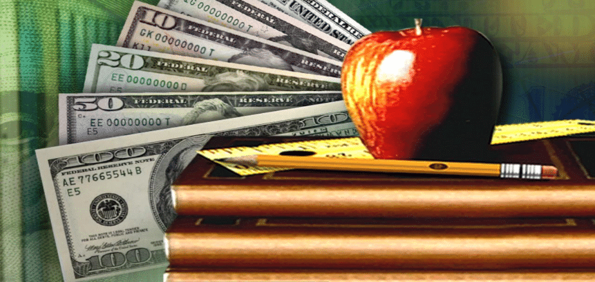 Apple, ruler and pencil on a desk with a backdrop of money