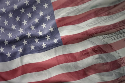 Colorful waving national flag of united states of america on a american dollar money background. finance concept