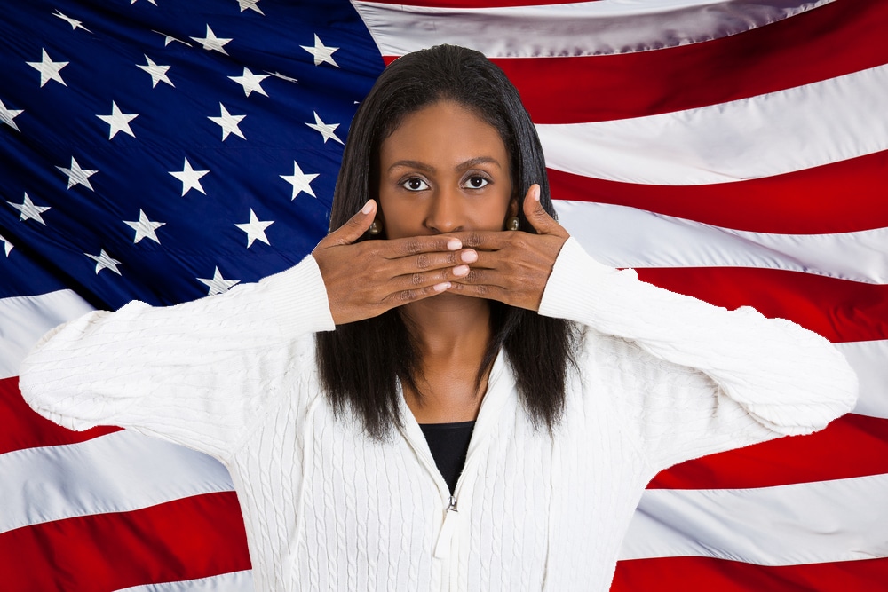 Woman covering her mouth to show concept of Free Speech