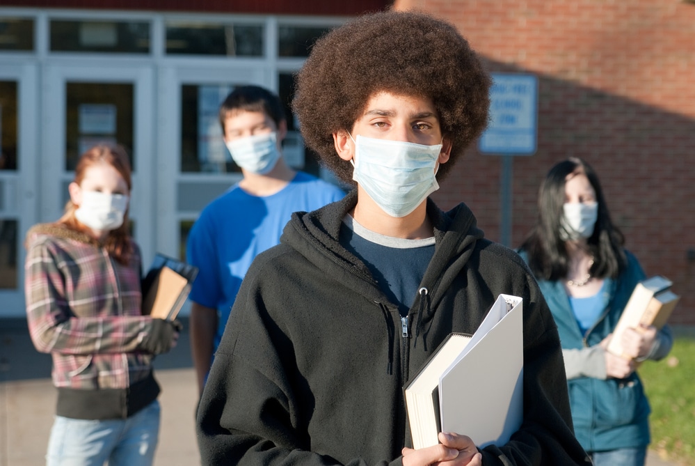 Students wearing masks outside school building
