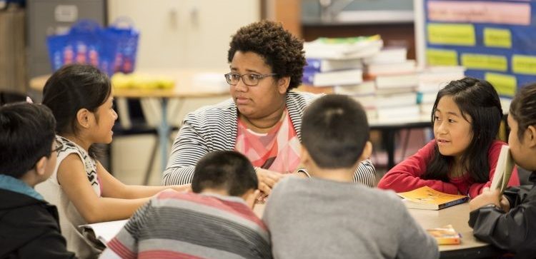 Teacher working with students in classroom