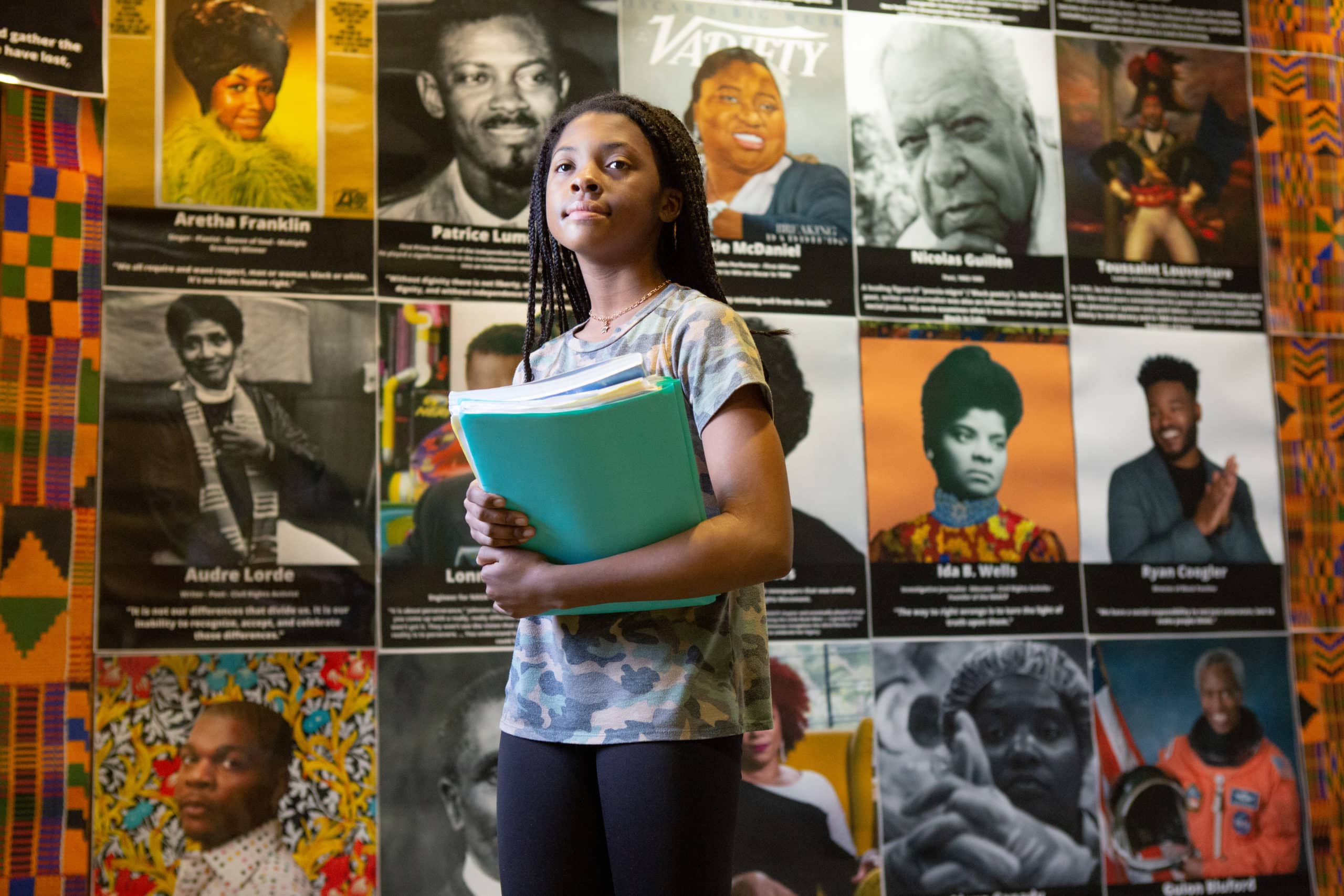 A seventh-grader walks by a Black History Month display at Sutton Middle School on her way to class.