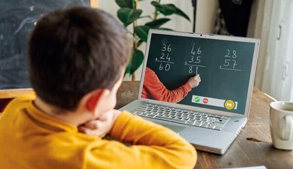 Boy using laptop to complete math assignment