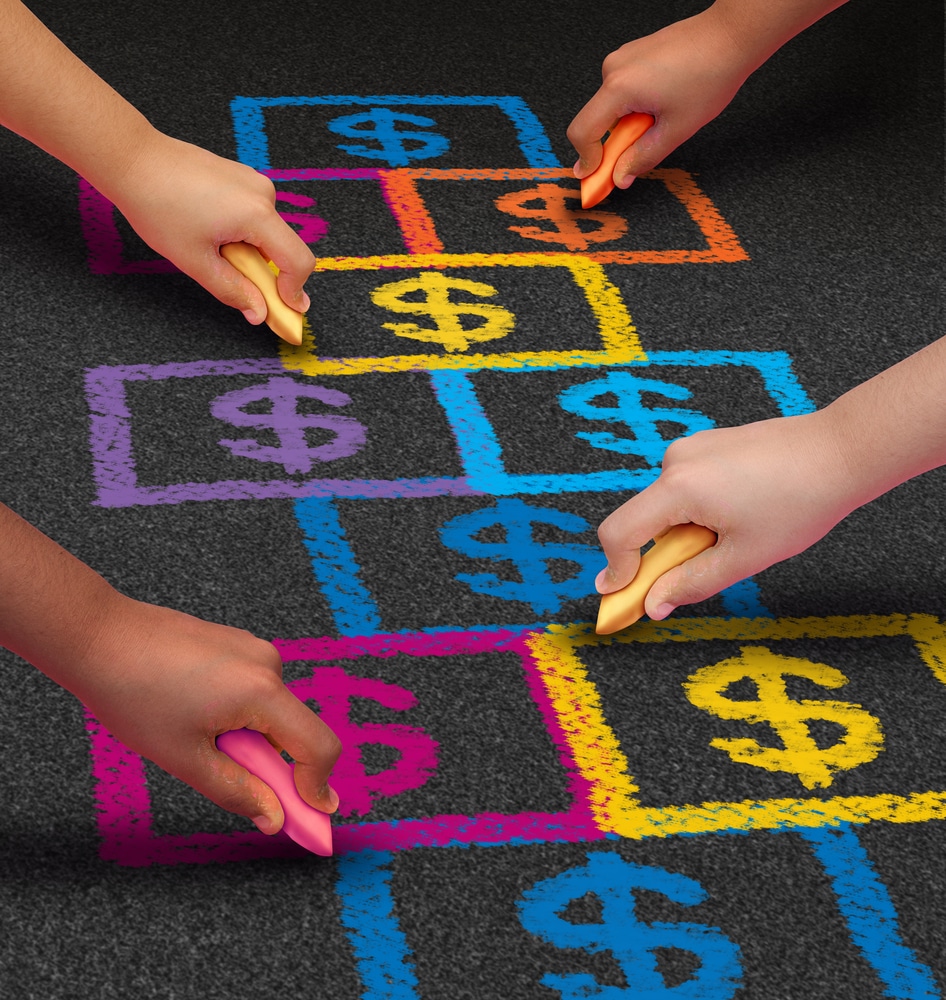 School financing and education business concept as a group of children drawing a hopscotch game on a floor with dollar signs as a symbol of student loans and paying for schooling fees.