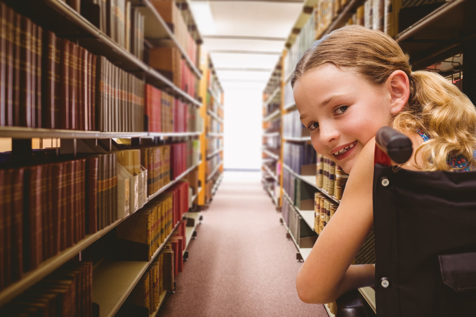 Portrait of cute girl sitting in wheelchair against close up of a bookshelf
